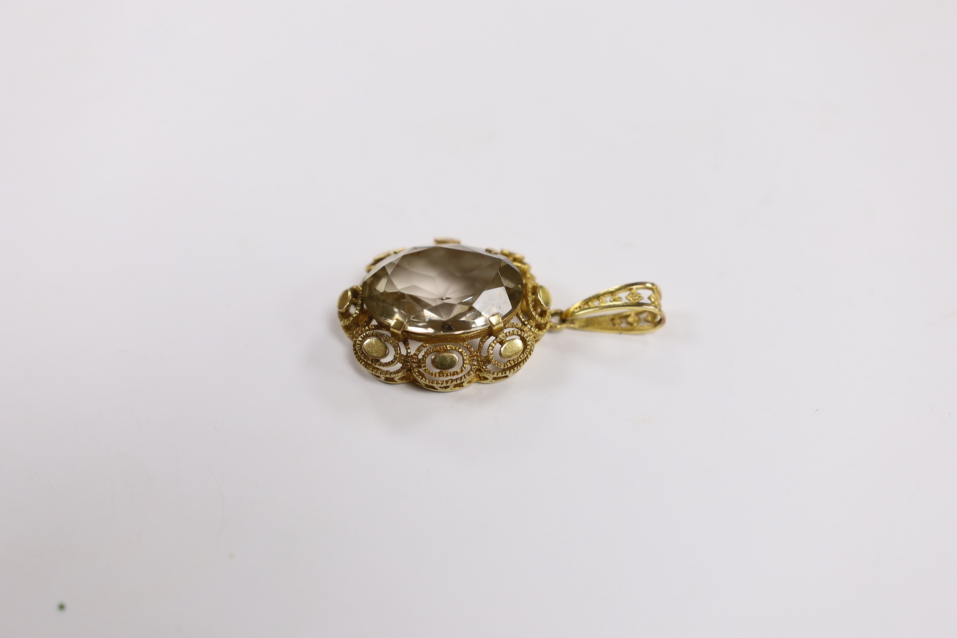A 9ct gold and single stone oval cut pale smoky quartz set pendant, 50mm, gross weight 12.7 grams.